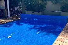 WaterMark solar pool cover under bench reel